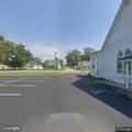 Suspicious person with flashlight near parked car