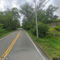 Report of leaning tree over Weaver Road