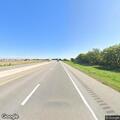 Man walking on highway median at mile marker 167