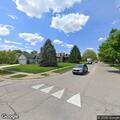Speeding silver vehicle near curve on Summer Road