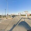 Person standing in roadway near Adams and Spalding