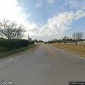 Person lying on road behind wellness center in Gautier