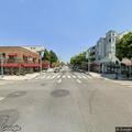 Man wrapped in blanket near Elm Street business