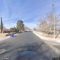 Trespassing woman lying near sidewalk in Las Cruces