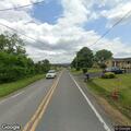 Vehicle crashes over embankment into building
