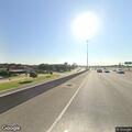 Traffic stop of silver Infiniti under highway overpass