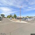 Barefoot person lying in road on West Allyn Street