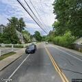 Woman walking outside near Court Street in Dedham