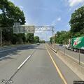 Two men fighting on highway shoulder near Exit 6A