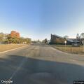 Man trying to push motorcycle appears disoriented