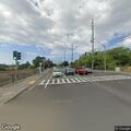 Man holding infant unsafely at car wash drive-through