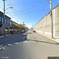 Woman sitting in middle of sidewalk