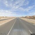 Car driving without headlights on Unser Boulevard