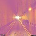 Vehicle with headlights on in westbound tunnel
