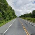 Woman barefoot walking and hitchhiking on Route 22 in Granville