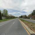 Person experiencing chest pain at bus stop