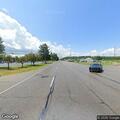 Possible unconscious person slumped over wheel on highway