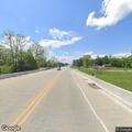 Vehicle stopped in road with person waving on highway
