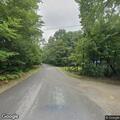 Confused elderly woman sitting in road on Blue Lake Road