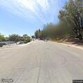 Car partially blocking sidewalk at intersection