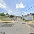 Person conscious on North 9th St by white RV