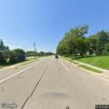 Person with hernia pain at traffic stop near Starbucks