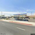 Woman slumped over wheel at gas station