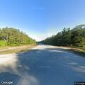 Car with flat tire on roadside in Kinross Township