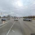 Person slumped over wheel in silver car at intersection