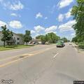 Running car parked in middle of Anoka street