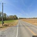 Large pieces of wood blocking roadway on IL 150