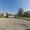 Woman in SUV going through trash cans