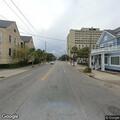 Illegally parked dark sedan at Ogier and Calhoun