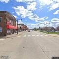 Barefoot woman walking on roadway in Albany