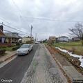 Man in hospital gown stumbling on street in Whitaker