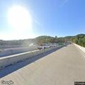 Black Nissan reported on highway near bridge