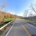 Vehicle rollover with injured man by roadway