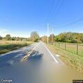 Vehicle stuck near canal on farm land