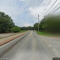 Officer checks burgundy vehicle at intersection