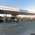 Officer checks orange Cadillac at Teachey gas station