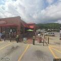Woman with blank stare enters store and walks behind counter