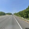 Pedestrian walking on highway ramp in Randolph