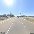 Road sign down in grass near Highway 55 and 100
