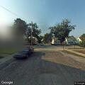 Person cutting wires in van behind residence