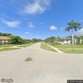 Person on bicycle looking into yards on Marco Island