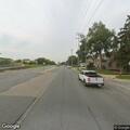 Person swinging arms on street corner