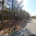 Small brush fire along roadway shoulder