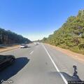 Stopped vehicle on highway shoulder with occupants