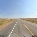 Man lying near road at intersection in Crowheart, WY