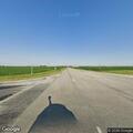 Car in ditch with person lying in back seat